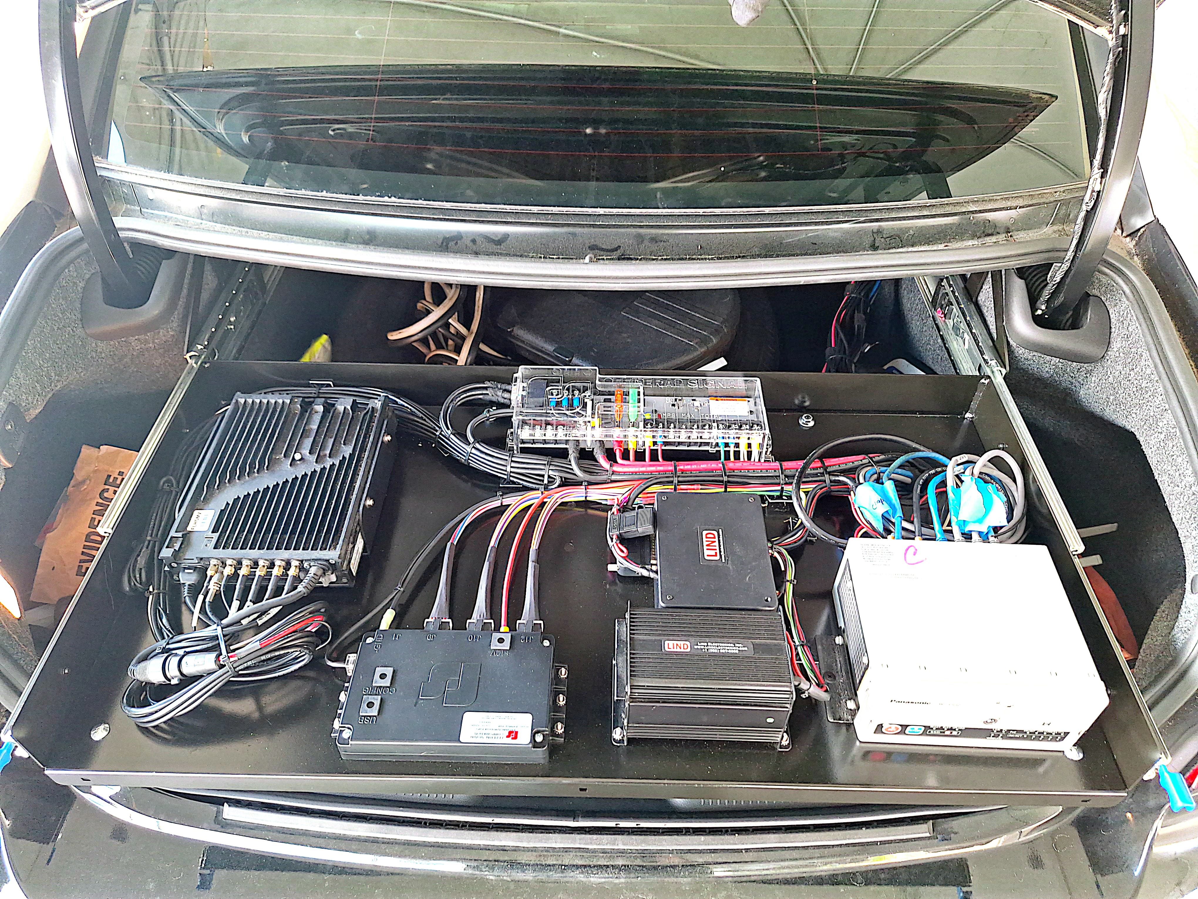 Fleet vehicle trunk electronics upfit with mounted equipment and organized wiring